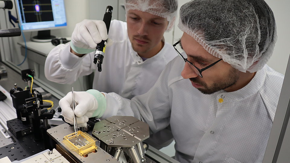 Two employees Looking at one micromodule