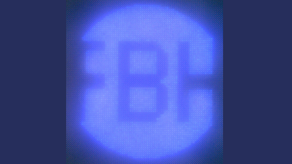 Fig. 3: Picture showing UV-luminescent pixel array of micro LEDs with a pixel diameter of 1.5 µm and a 2 µm pitch shaped as FBH logo (diameter 158 µm) under the microscope.