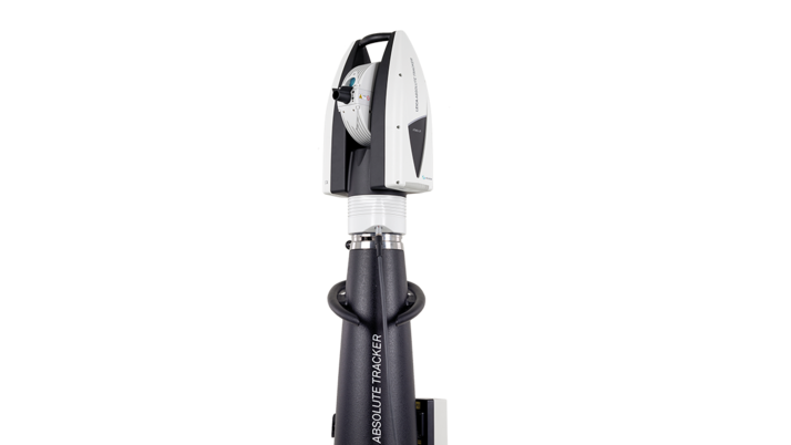 A black, sturdy stand with three feet and a sensor head on the top. The sensor is movable and transmits and receives laser radiation. The device is used for precise measurement and is labeled as a “Leica Absolute Tracker”.