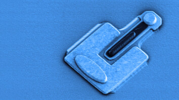 Grayscale SEM image of an Indium phosphide heterojunction bipolar transistor, colored in light blue. 