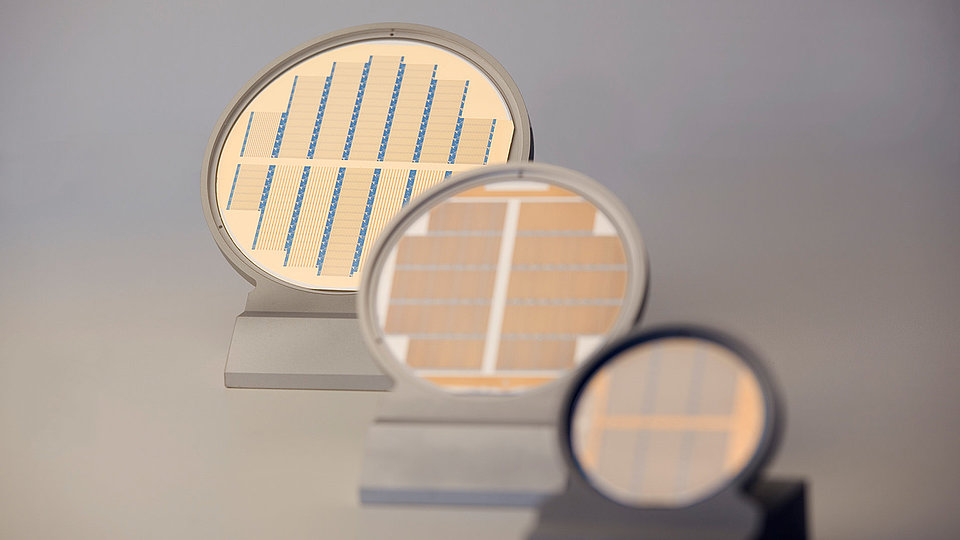 Processed 2-, 3- and 4-inch laser wafers in holders arranged in a row