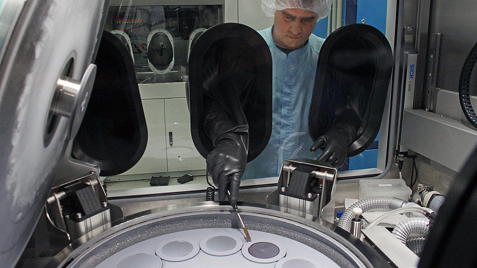 Technician loading wafers into the epitaxy reactor for metal organic vapor phase epitaxy