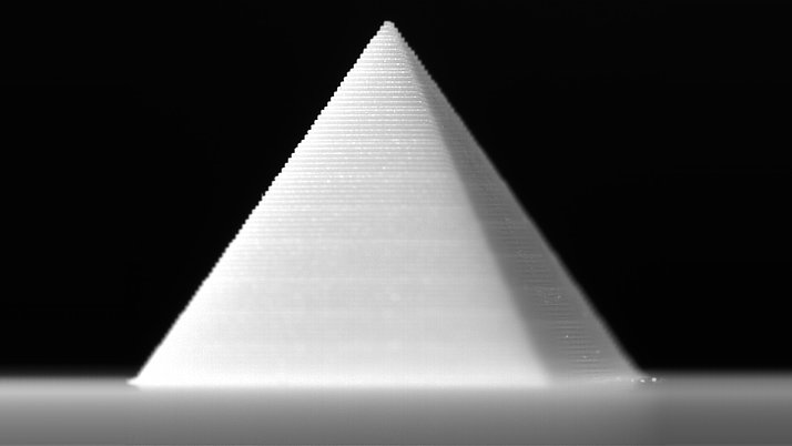 A white cone with clear horizontal stripes can be seen against a black background.