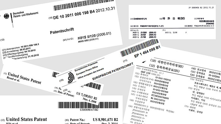 Collage of several patent specifications from various countries, including Germany, the USA and Japan. Information such as file numbers, filing dates and patent numbers are presented.