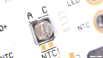 UV LED planar AlN submount with NGK elliptical quartz lens on PCB