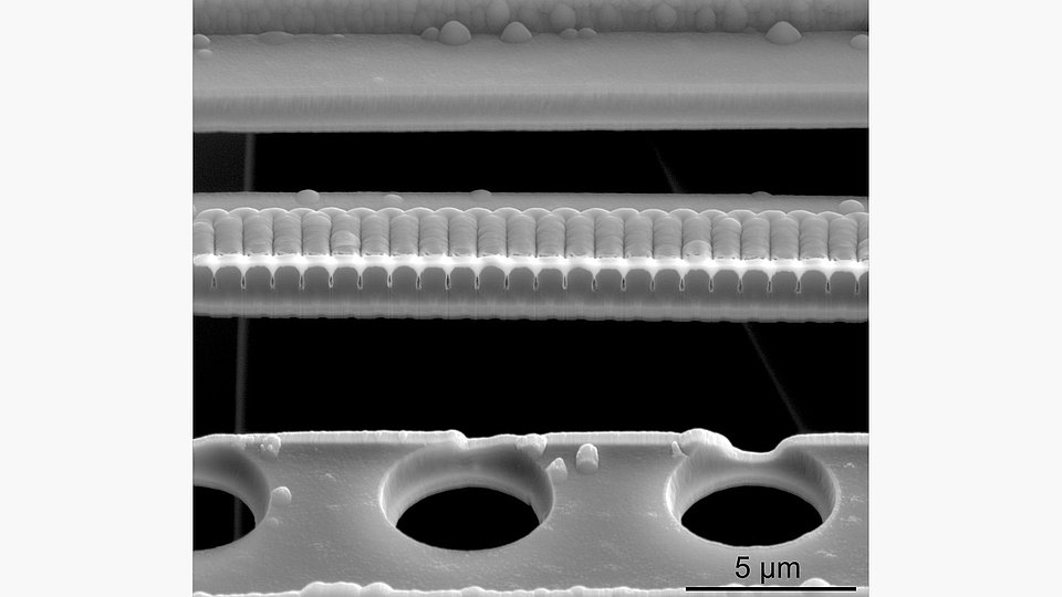 SEM micrograph showing a cross-sectional FIB cut in a silicon oxide-based waveguide.