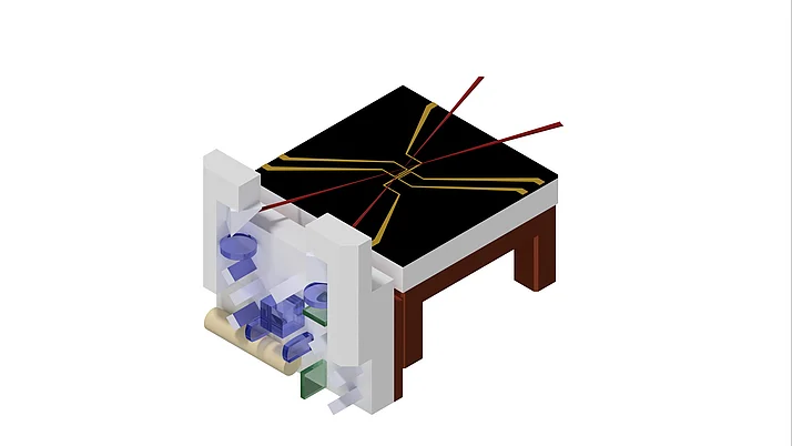 Darstellung einer Vorrichtung zur Chipmontage. Die Platte hat ein schwarzes Oberflächenmuster mit gelben und roten Linien. Unter der Platte sind verschiedene farbige Bauteile sichtbar.